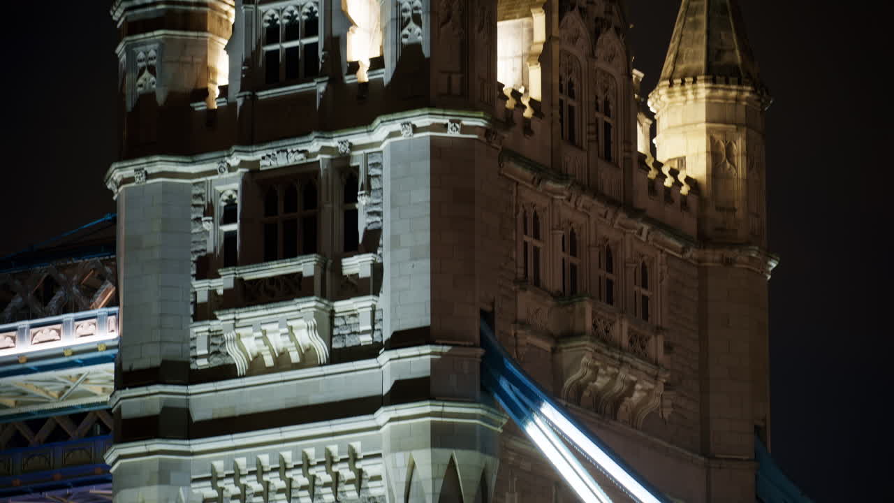 Close-up of the Tower Bridge with light trails from traffic at night in London, England