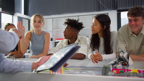 Close-Up-Of-Female-Teacher-With-Digital-Tablet-Teaching-High-School-Student-STEM-Class