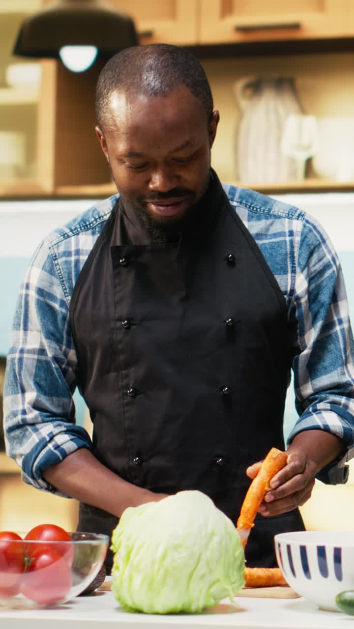 Vertical Video African american people cutting fresh vegetables on a cutting board at home