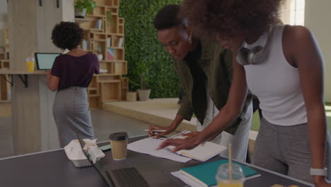 professional black business women brainstorming creative team sharing ideas enjoying collaborating colleagues working together in trendy office workplace