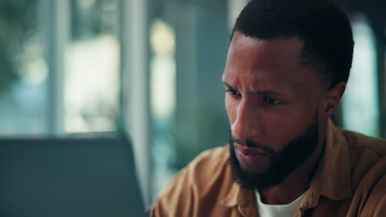 Man with beard looking at computer screen