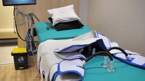Slow-motion-establishing-shot-of-EECO-physical-therapy-equipment-lying-on-the-bed