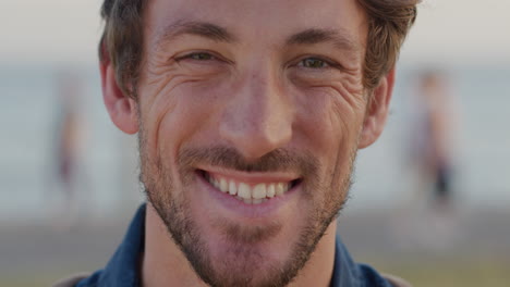 portrait young man smiling outdoors at ocean enjoying stress free lifestyle