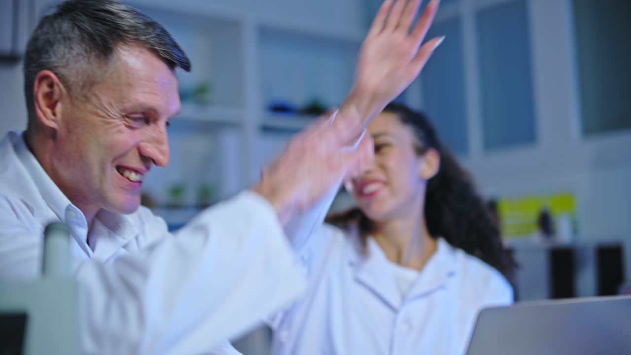 científicos de laboratorios médicos felices dando los cinco altos, descubriendo el tratamiento de la enfermedad