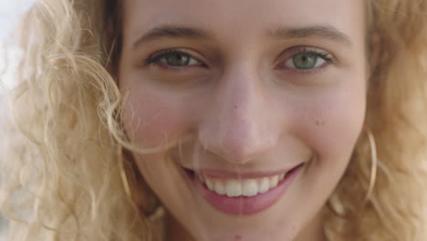 close up portrait of attractive young blonde woman face smiling happy looking at camera enjoying lifestyle