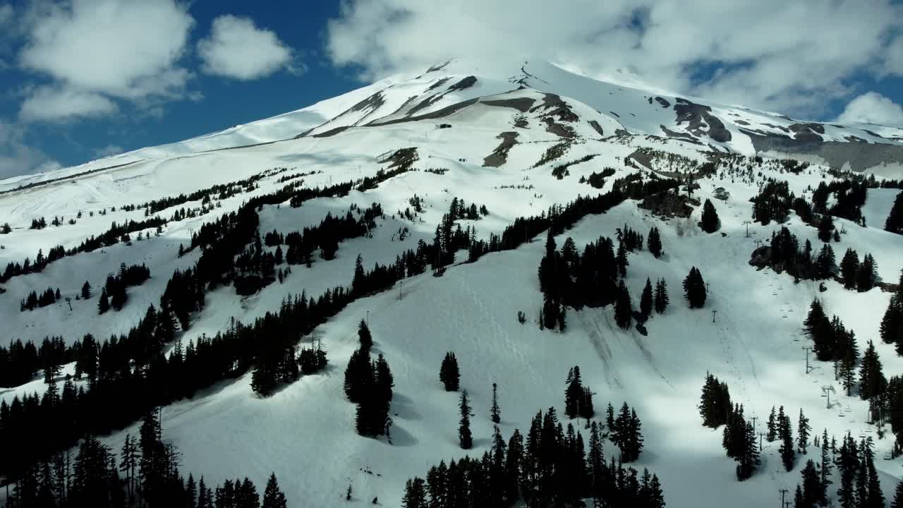 US, Oregon, Mt Hood, Meadows Ski Area, 2025-04-22 - Drone view of Mt Hood at the Mt Hood Meadows ski area in spring. Flying up the ski runs and lifts.