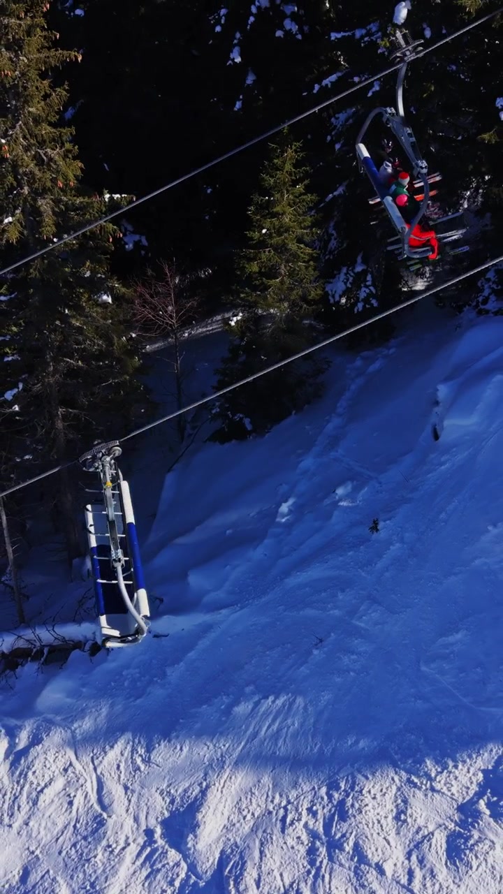 Skier riding a chairlift in the Carpathians mountains of Bulgaria