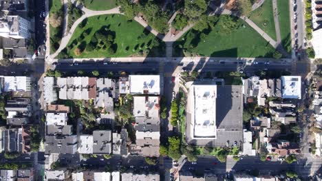 Aerial-view-of-Alamo-Square-Park-in-San-Francisco,-showcasing-the-lush-greenery-and-iconic-Victorian-houses