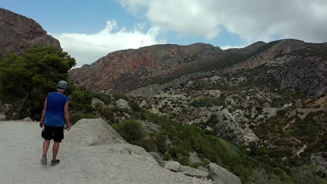 tourist looking over the valley of el cabrito ornithological observatory, spain