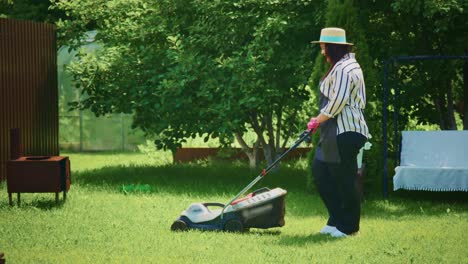 woman mowing the lawn in a garden