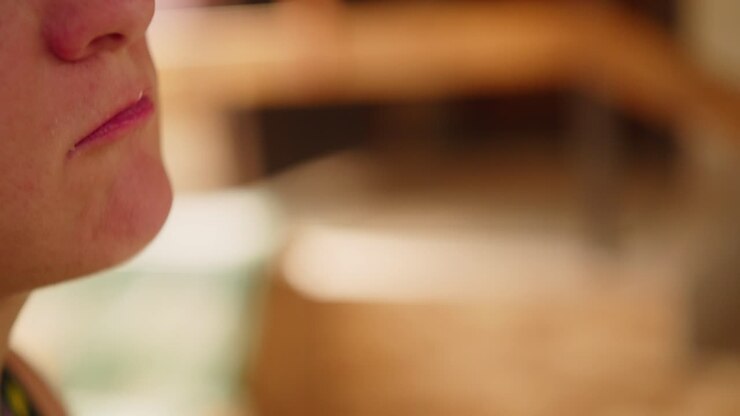 Close up of woman putting a piece of cake on a fork in her mouth 50fps