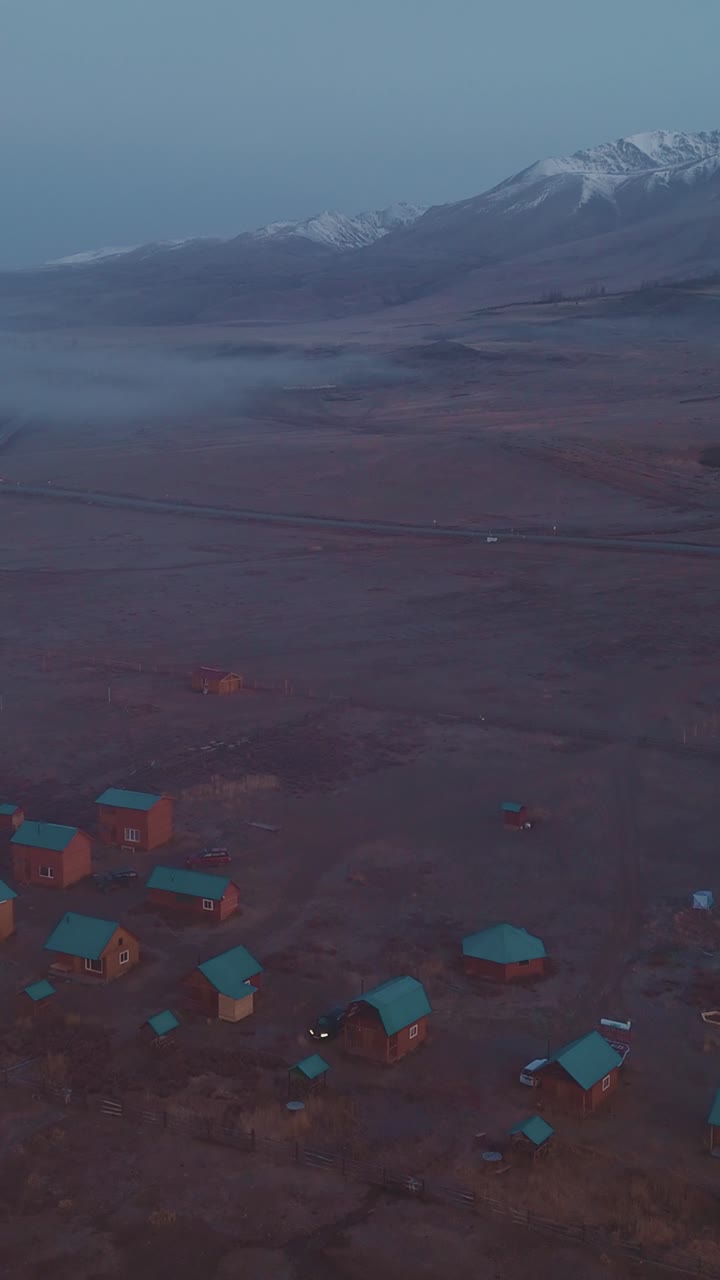 Aerial View of Remote Mountain Village in Fog at Twilight