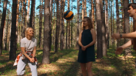 people playing volleyball in a forest