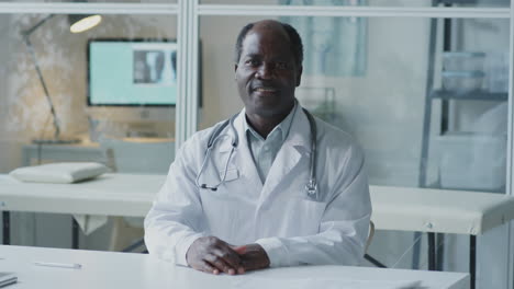 portrait of a friendly african american doctor in his office