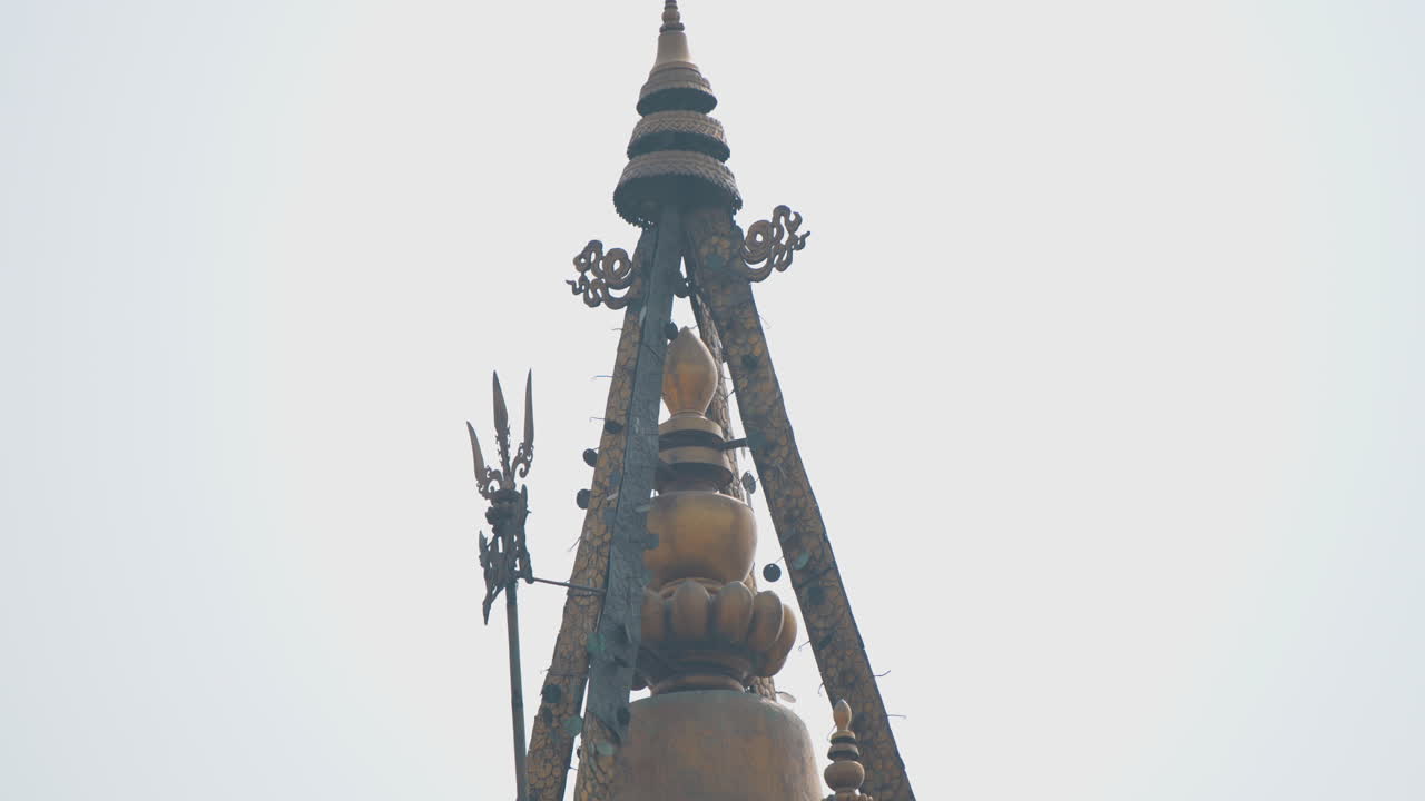 Close-up of a temple pinnacle in Kathmandu, Nepal, showcasing ancient Nepali design, spiritual symbolism, and cultural architecture that reflects the artistic and religious richness of Nepal