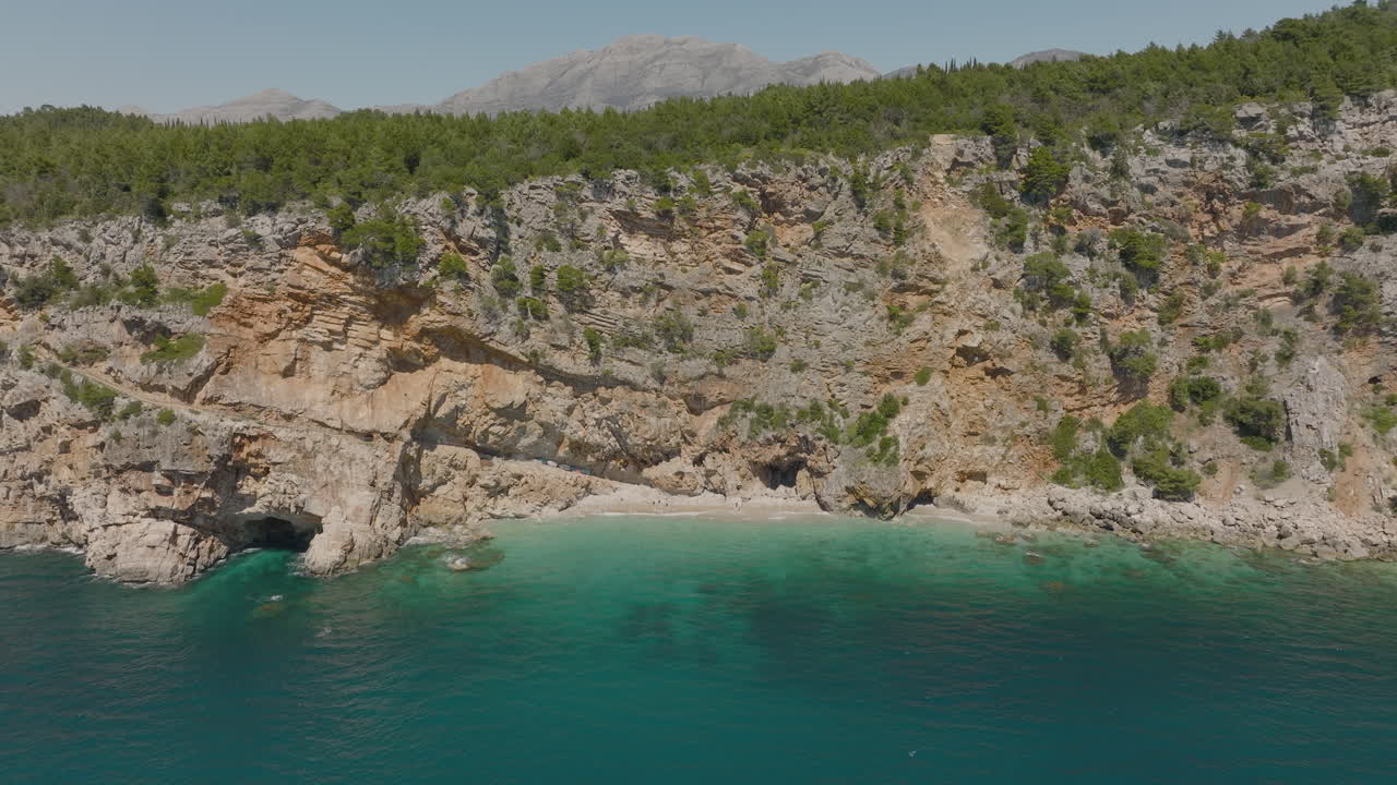 Aerial 5K Drone Flyover Secluded Cliffside Beach With Clear Turquoise Sea In Dubrovnik, Croatia