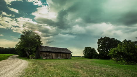 time lapse of an eerie shed or warehouse on a daylight at an open field