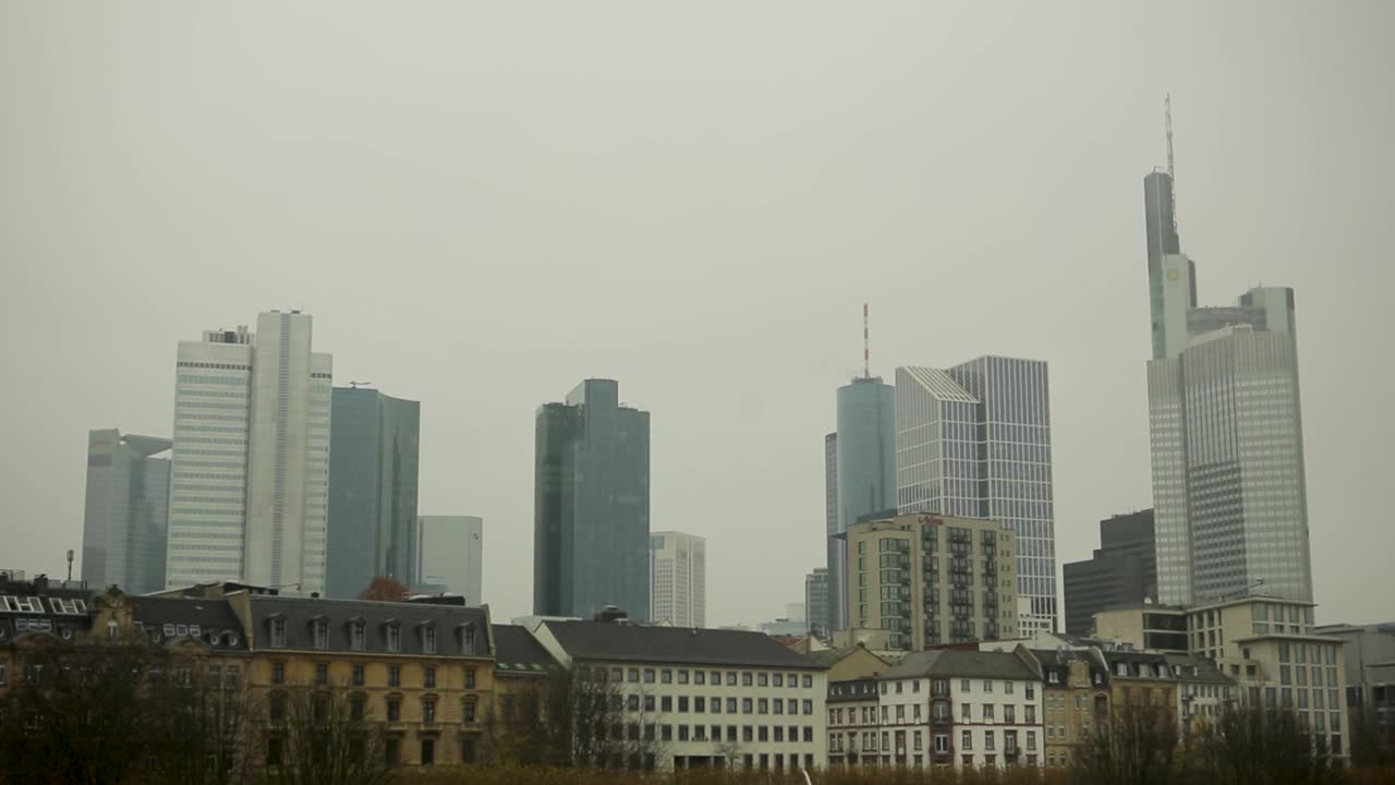 Frankfurt's skyline on a cloudy day with modern skyscrapers and historic buildings