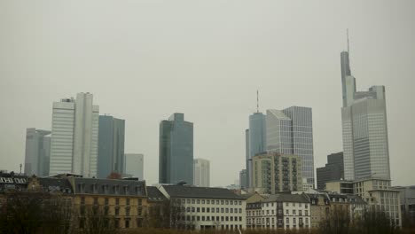 frankfurt's skyline on a cloudy day with modern skyscrapers and historic buildings