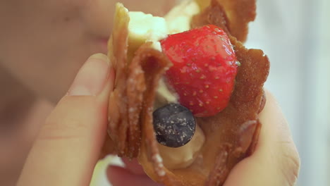 Girl-enjoying-dessert-with-cream-and-fresh-berries