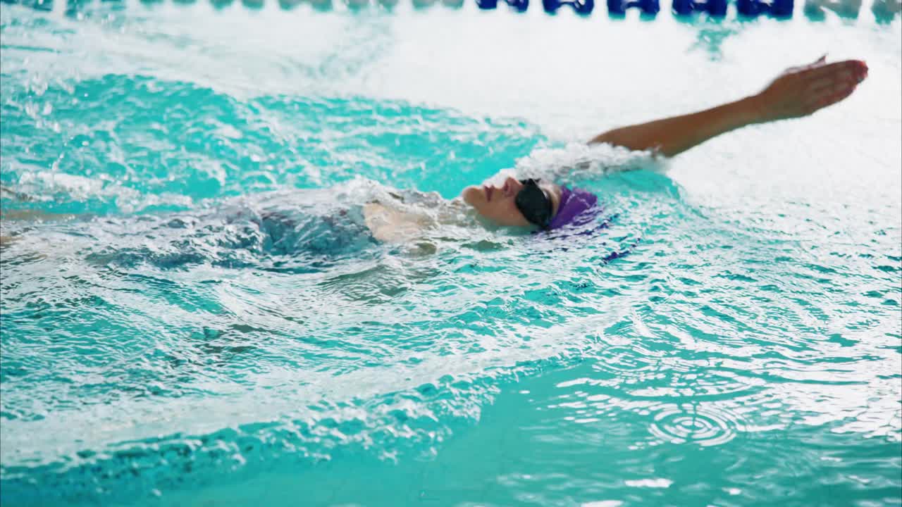 Dedicated swimmer gliding through a vibrant pool, showcasing skillful strokes while maintaining focus and rhythm in the refreshing water environment