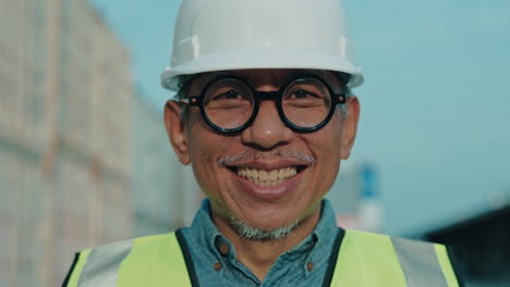 smiling engineer at a shipping container facility