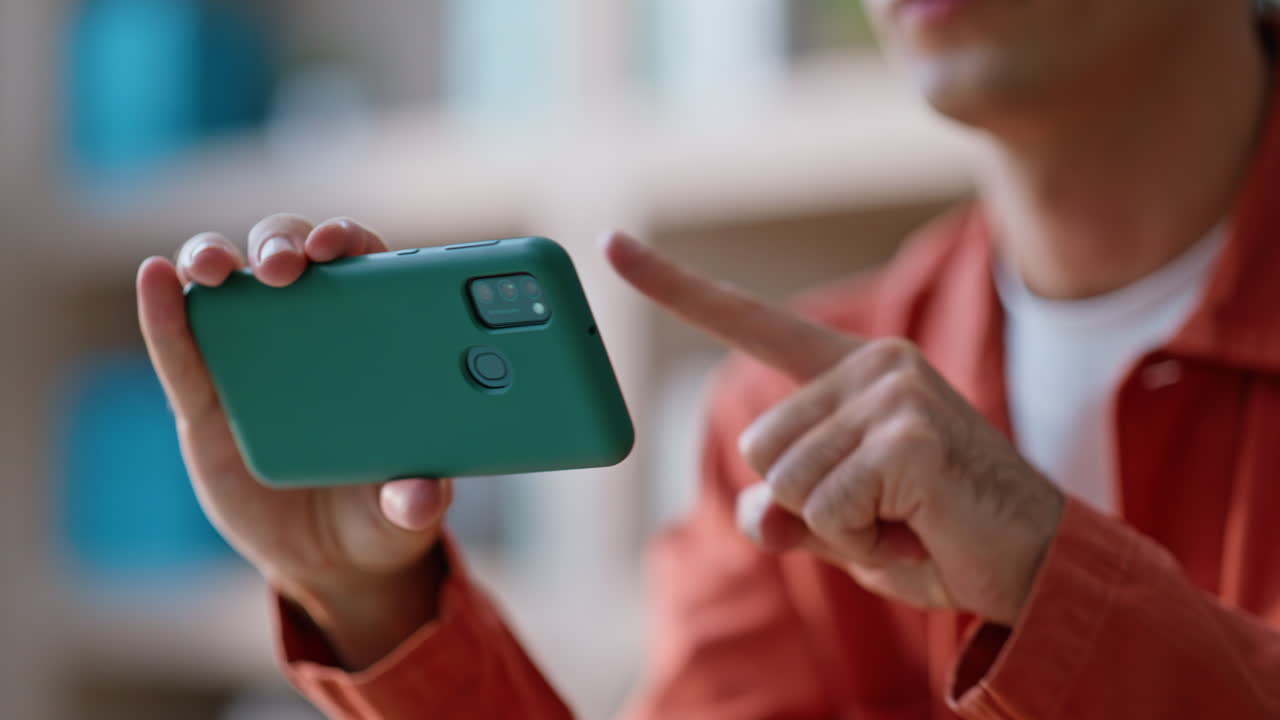 Employee shopping online cellphone relaxing at apartment closeup. Man browsing