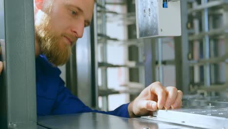 Robotic-engineer-examine-robotic-machine-in-warehouse-4k