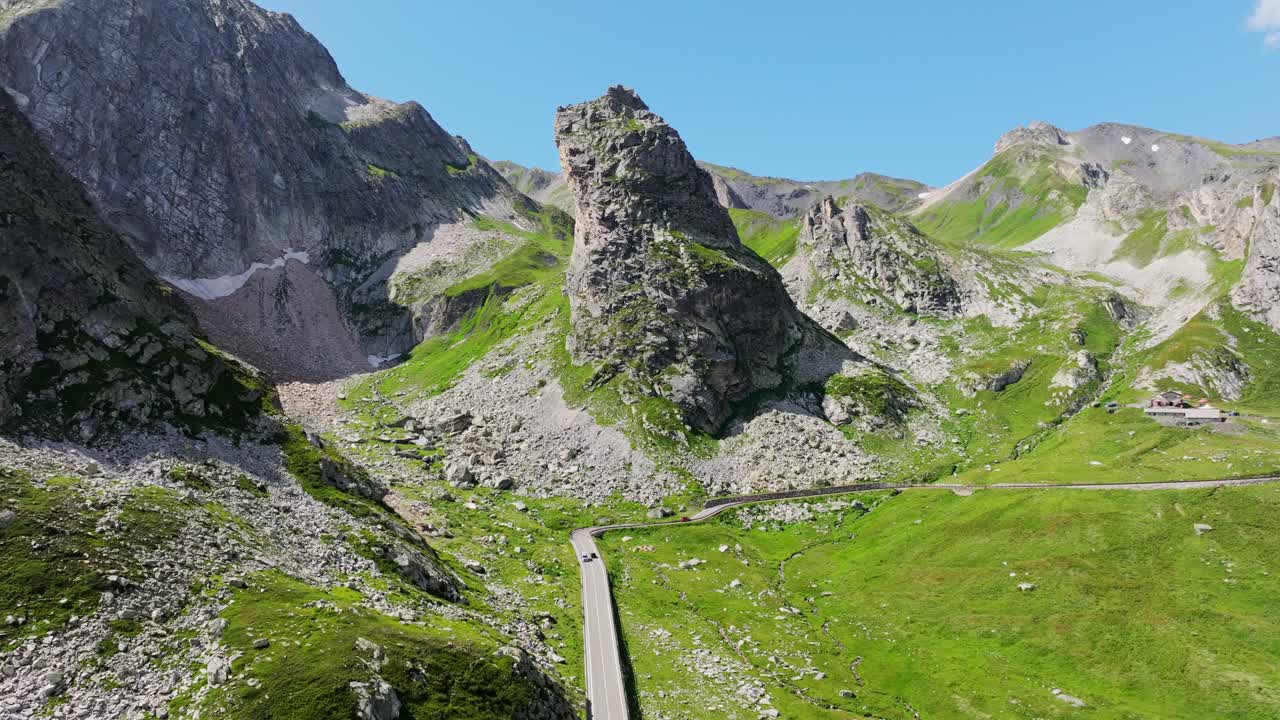 Grand Saint Bernard Pass, winding mountain road through towering rock formations