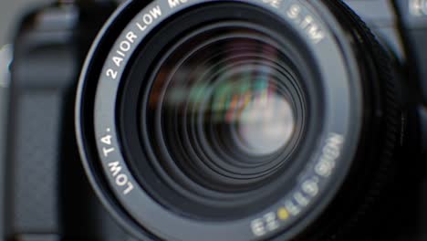 Exploring the Depths of Focus: A Close-Up View of a Camera Lens Capturing Light and Color Reflections from Its Surroundings