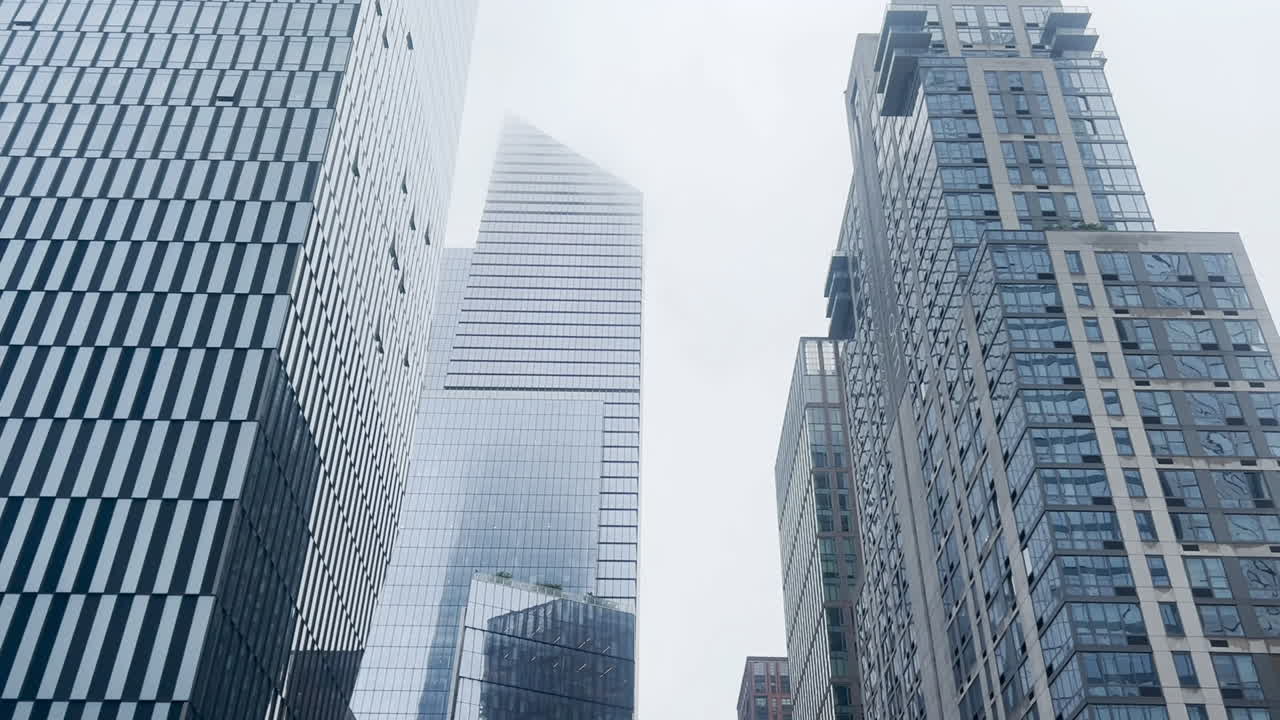 Modern skyscrapers rising in Manhattan fog
