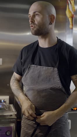chef in an apron in a kitchen setting