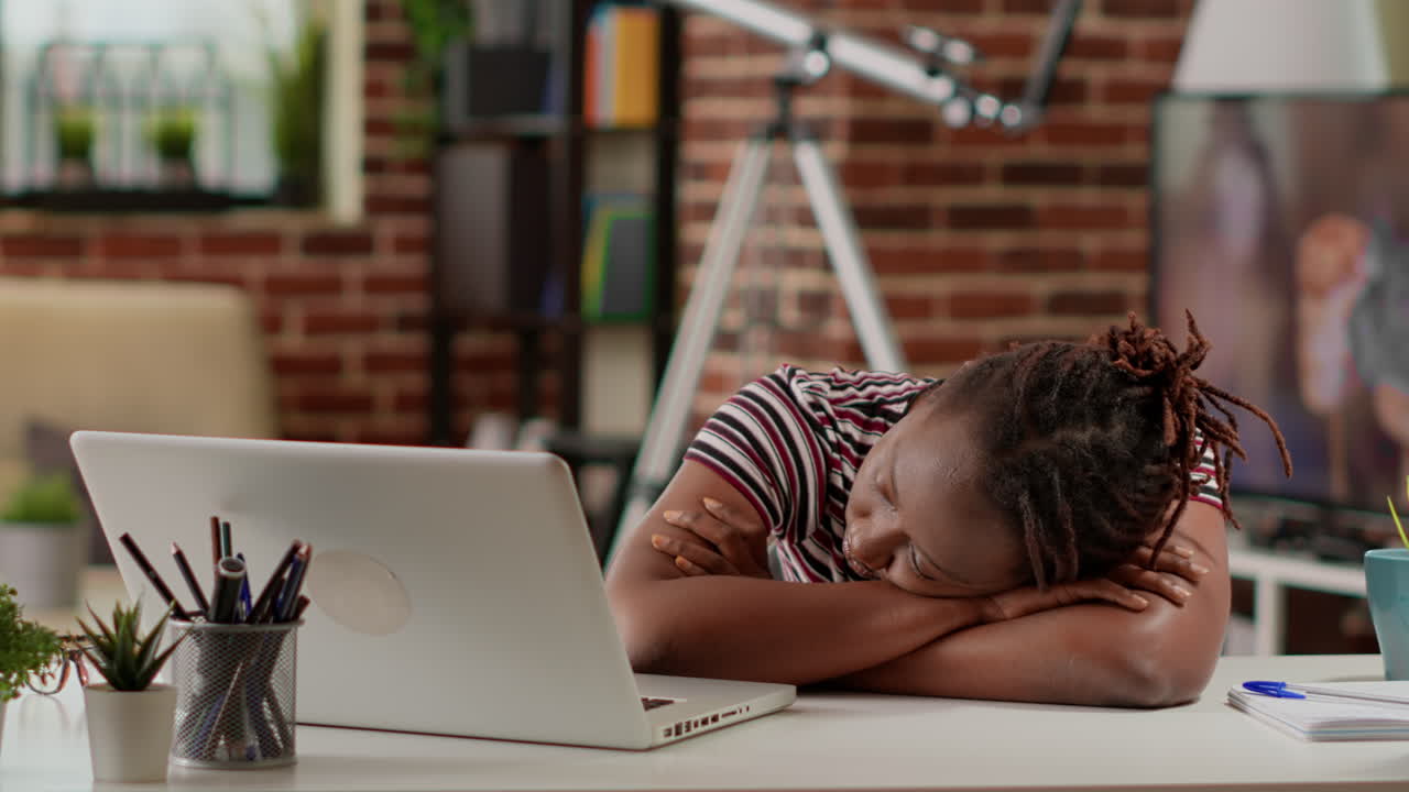 Woman sleeping at desk with laptop