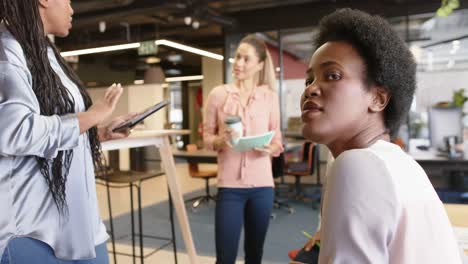 portrait of african american businesswoman in wheelchair with colleagues at meeting, slow motion