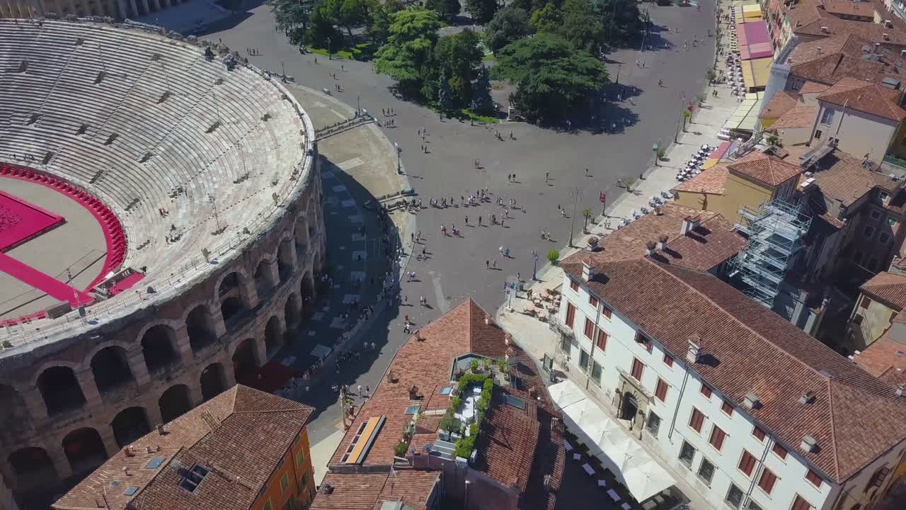 Aerial panoramic view of Arena di Verona, Italy. The drone flies from Bra Square to houses and flies over rooftops. A view of the Arena and the city opens. 4k vieo.