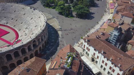 aerial panoramic view of arena di verona, italy. the drone flies from bra square to houses and flies over rooftops. a view of the arena and the city opens. 4k vieo.