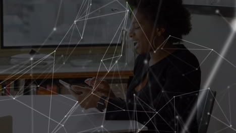 animation of networks of connections with icons over woman using tablet
