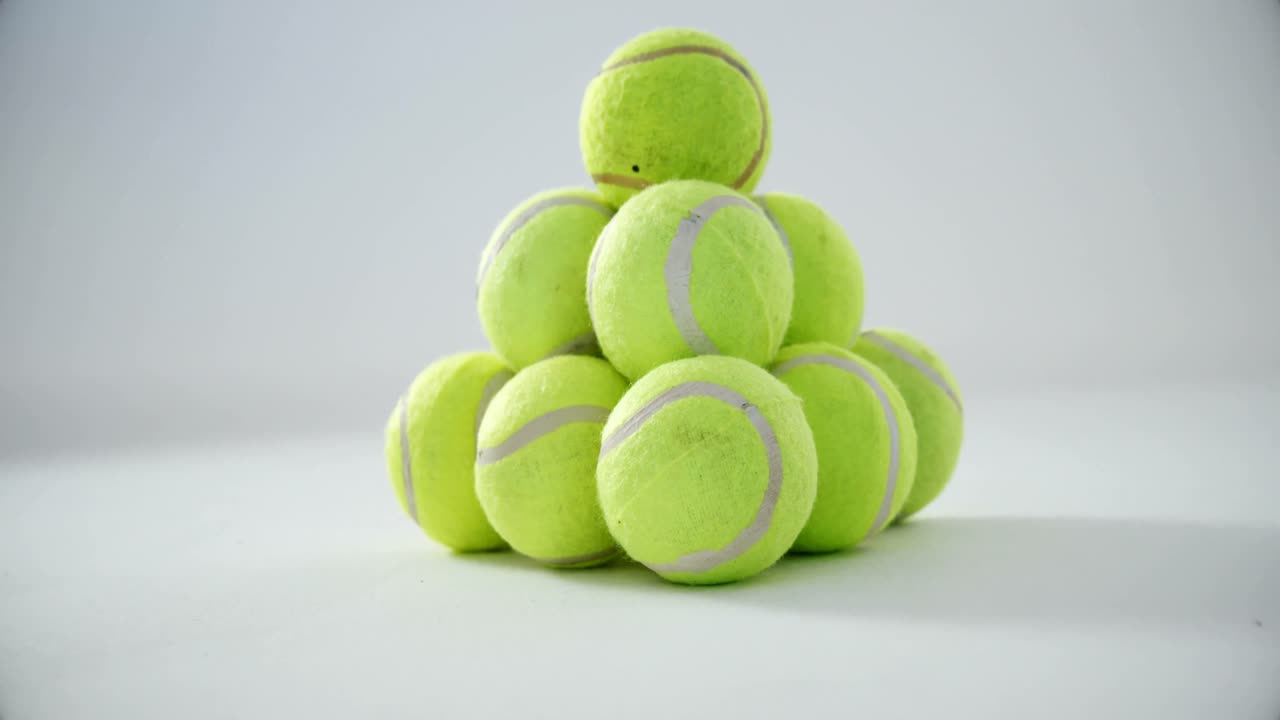 Stack of tennis balls on white background 4k