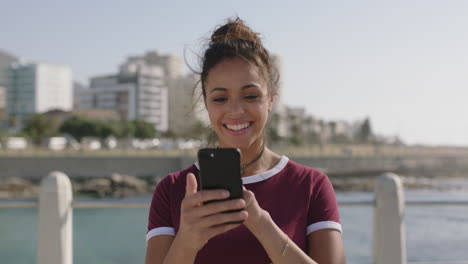 portrait of young beautiful hispanic woman smiling happy using smarphone on beachfront feeling excited winning