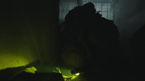 military personnel in a dark, abandoned building