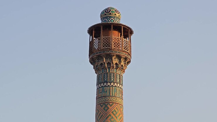 Minareto elaborato di una moschea persiana tradizionale contro un cielo sereno