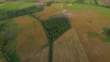 Country-side-panoramic-landscape-in-summer-time-from-above-and-ground-with-hay-rolls-and-roads