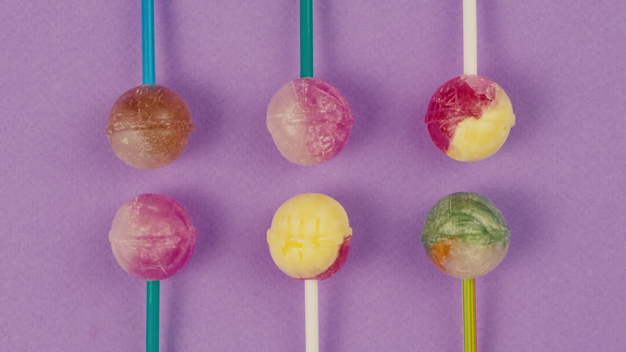 Colorful Lollipops on Purple Background