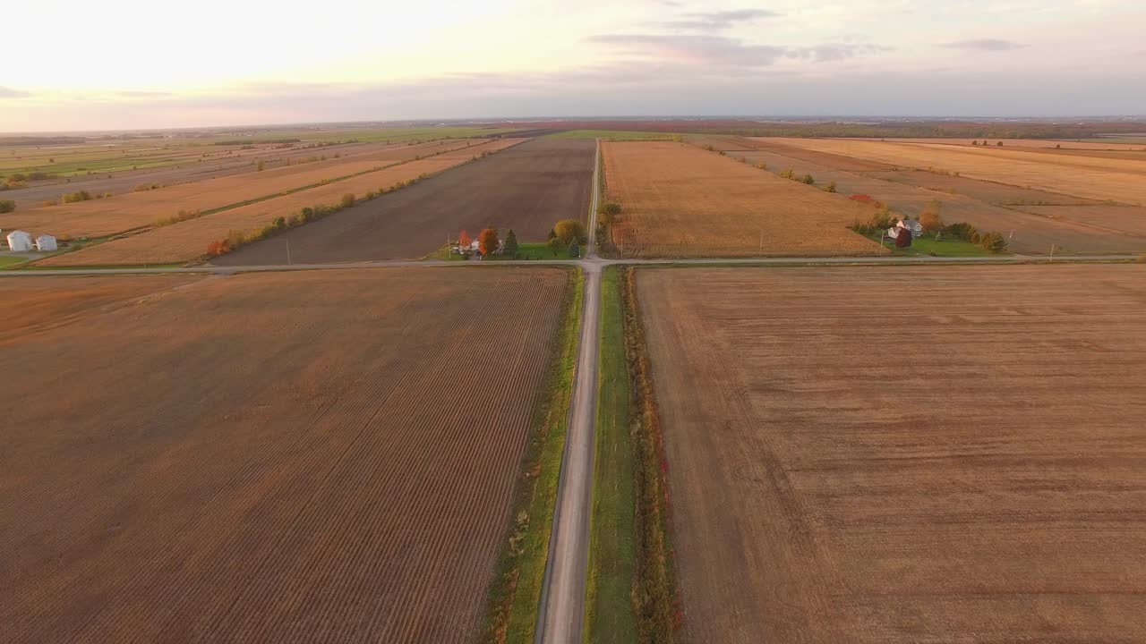Aerial view of flat open farmland with freshly plowed fields and plots ready for harvest