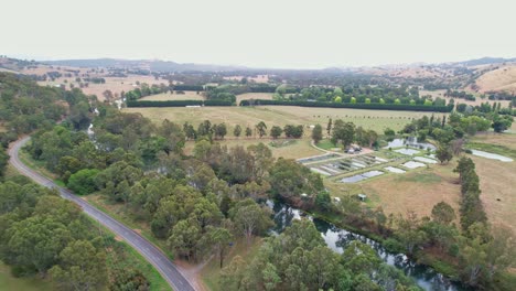 Over-a-road-and-the-Goulburn-River-with-paddocks-and-ponds-in-the-background-near-Eildon,-Victoria,-Australia