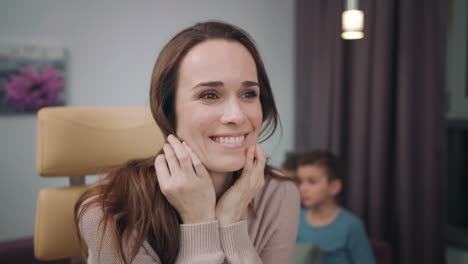 cheerful mother laughing at home workplace