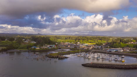 Aerial-View-Of-Boats-And-Wooden-Poles-In-The-Waters-Of-Coquille-River---Port-Of-Bandon-In-Oregon---hyperlapse