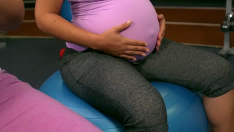 pregnant women sitting on exercise balls