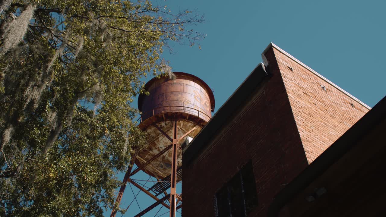 Tilt up shot of historic brick tower building in old construction city