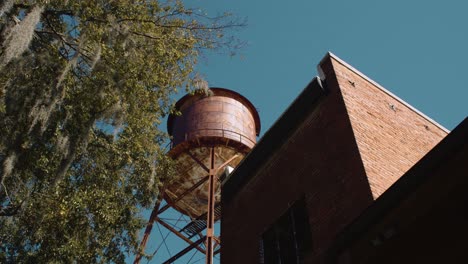 tilt up shot of historic brick tower building in old construction city